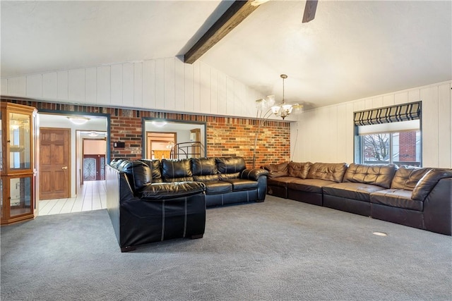 carpeted living room with vaulted ceiling with beams, wooden walls, and an inviting chandelier