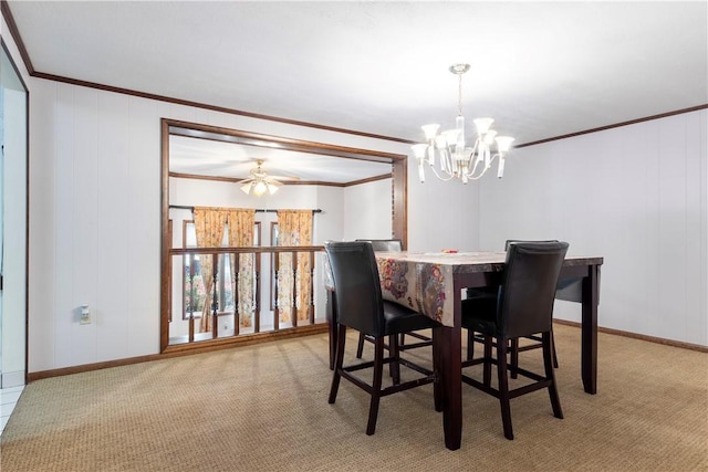 carpeted dining room featuring ceiling fan with notable chandelier and ornamental molding