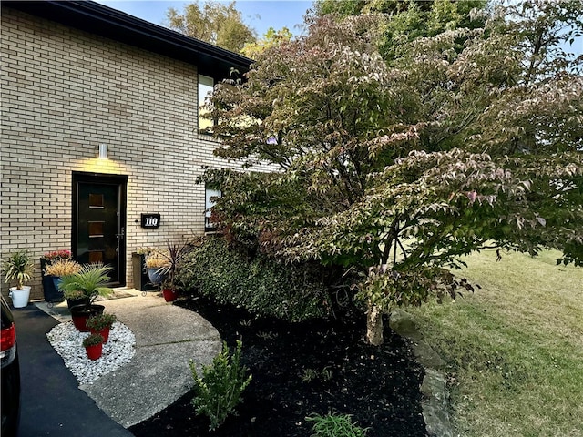 view of exterior entry with a lawn