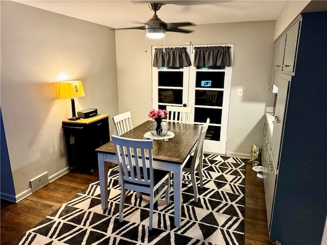 dining space with ceiling fan and dark wood-type flooring