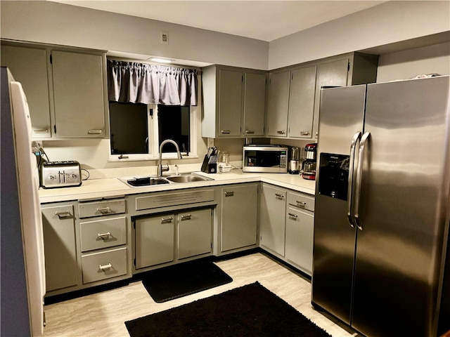 kitchen with sink and appliances with stainless steel finishes