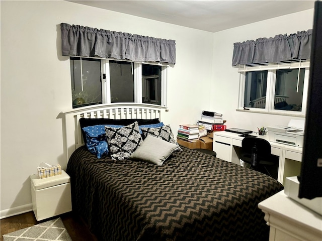 bedroom with dark hardwood / wood-style floors