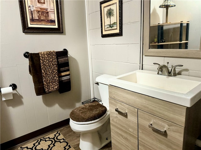 bathroom featuring toilet, hardwood / wood-style floors, and vanity