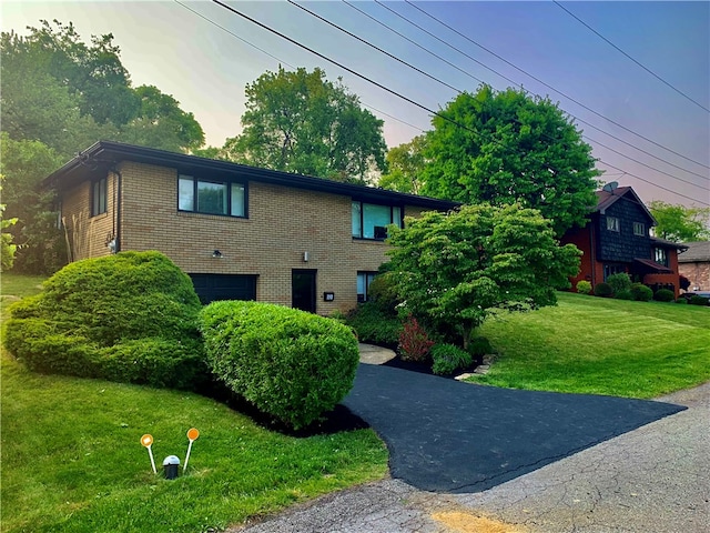 view of front of home with a front lawn and a garage