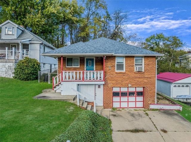 view of front of house with a garage, a front lawn, and a porch