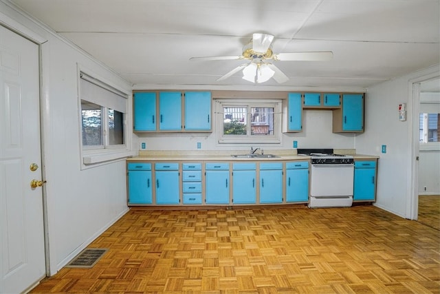 kitchen featuring light parquet flooring, sink, white range, blue cabinets, and ceiling fan