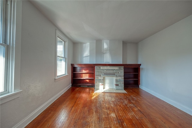 unfurnished living room with hardwood / wood-style floors and a fireplace