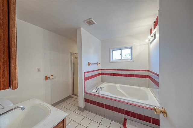 bathroom featuring vanity, independent shower and bath, and tile patterned floors