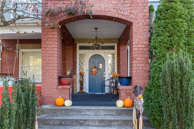 view of exterior entry featuring covered porch