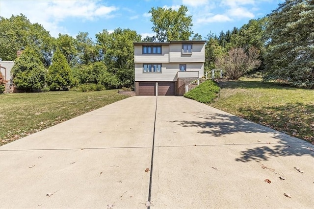 view of front of house featuring stairway, driveway, a front lawn, and an attached garage