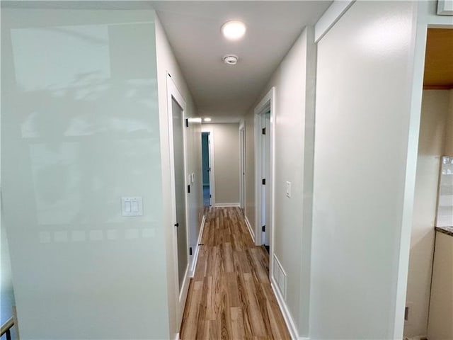 hall with light hardwood / wood-style floors