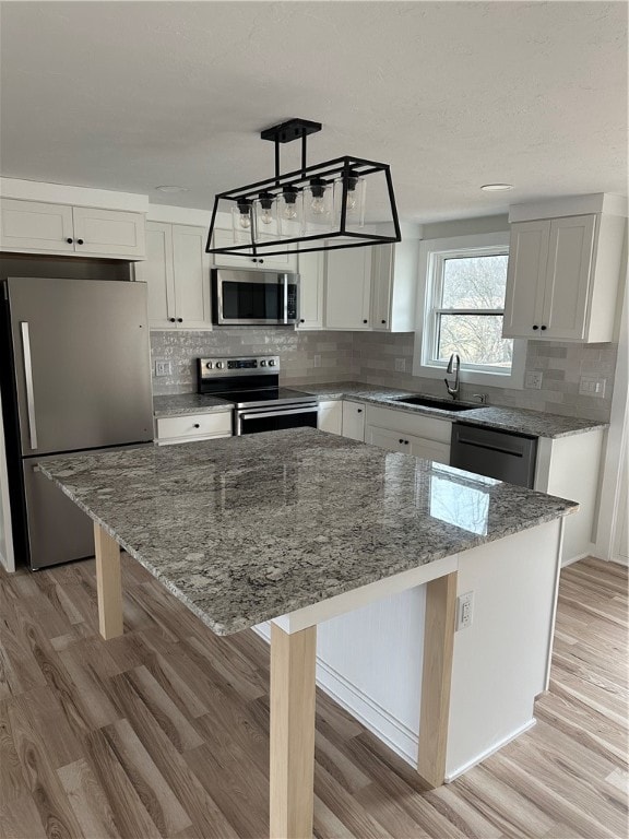 kitchen featuring a center island, stainless steel appliances, and sink