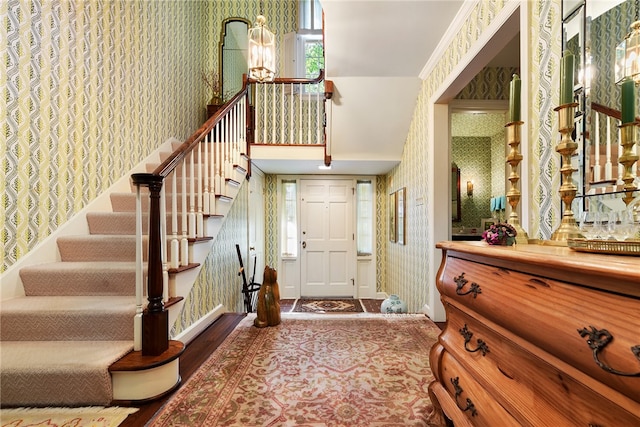 entrance foyer with crown molding and hardwood / wood-style flooring