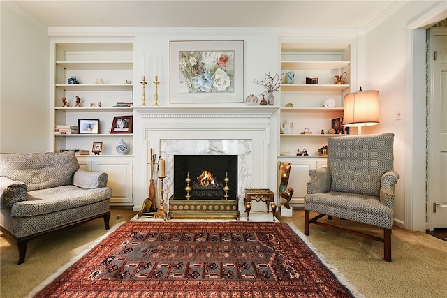 sitting room featuring carpet flooring, built in features, ornamental molding, and a fireplace