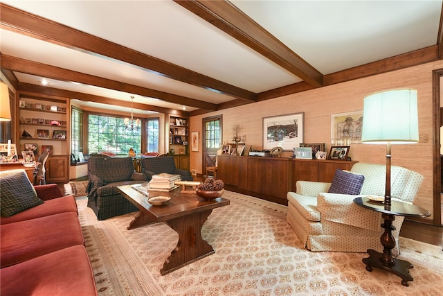 living room with beam ceiling and a chandelier