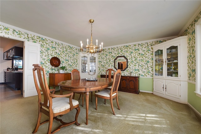 carpeted dining area featuring an inviting chandelier and crown molding