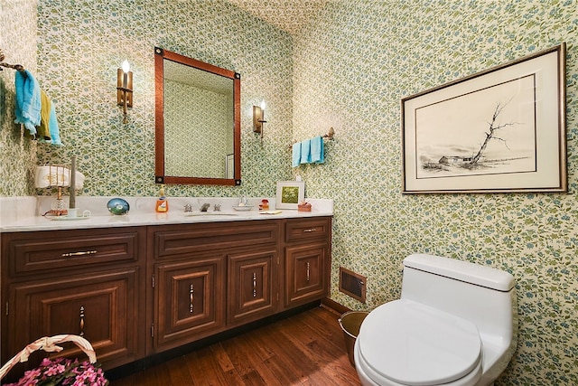 bathroom with vanity, wood-type flooring, and toilet