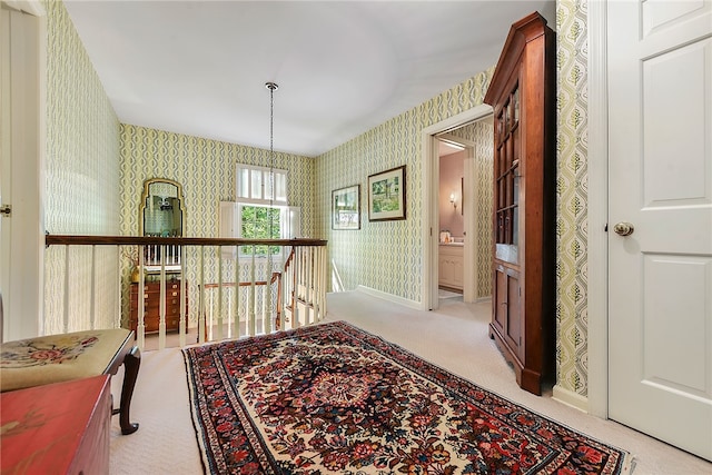 hallway featuring light carpet