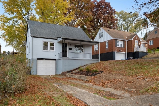 bungalow-style house with covered porch and a garage