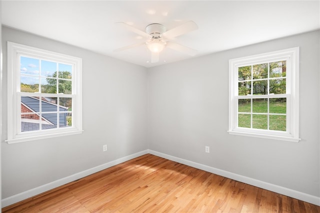 empty room with ceiling fan, light hardwood / wood-style flooring, and plenty of natural light