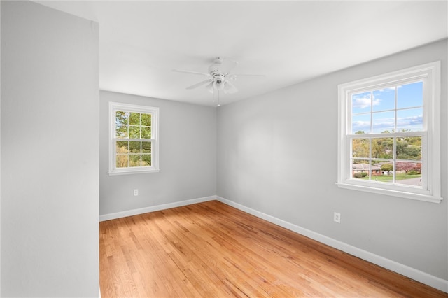 empty room with light wood-type flooring and ceiling fan