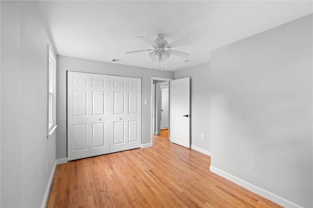 unfurnished bedroom with a closet, ceiling fan, and light wood-type flooring