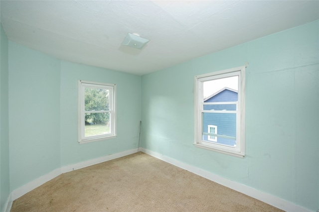 unfurnished room featuring light carpet