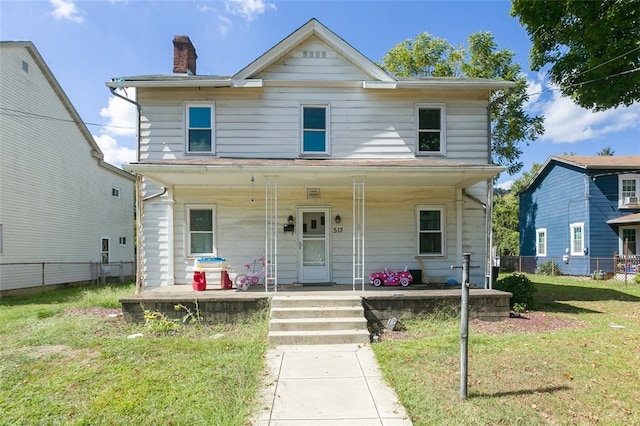 view of front facade with a front yard and a porch