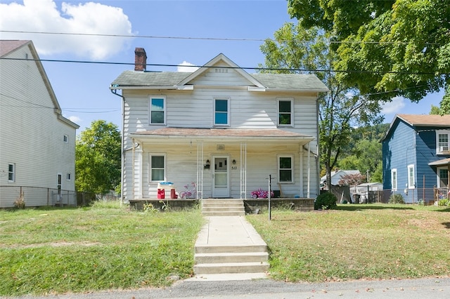 view of front of home featuring a front yard and covered porch