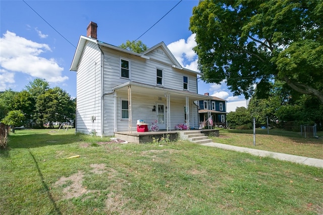 view of front of property with covered porch and a front lawn