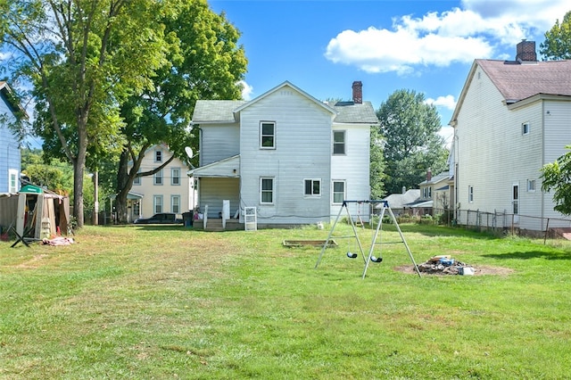 rear view of house with a yard