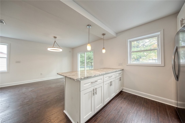 kitchen featuring light stone countertops, kitchen peninsula, white cabinetry, decorative light fixtures, and stainless steel refrigerator