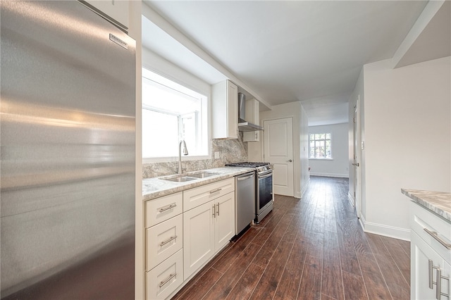 kitchen featuring backsplash, stainless steel appliances, dark wood-type flooring, sink, and light stone counters