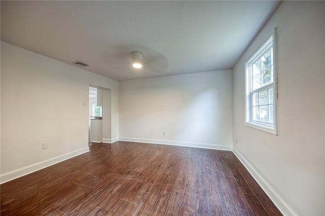 unfurnished room with dark hardwood / wood-style floors