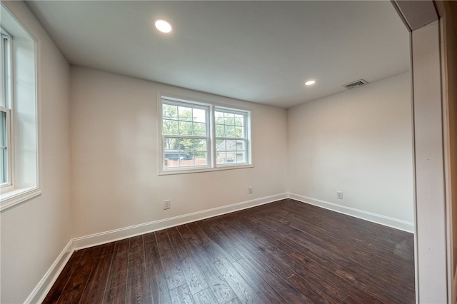 spare room with dark hardwood / wood-style flooring