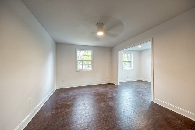 spare room featuring ceiling fan and dark hardwood / wood-style floors