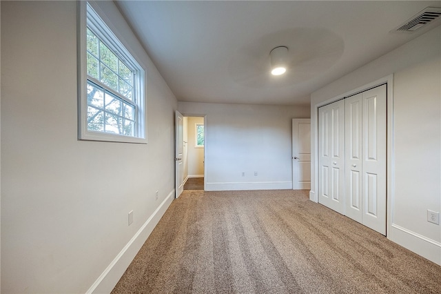 unfurnished bedroom featuring a closet and carpet floors