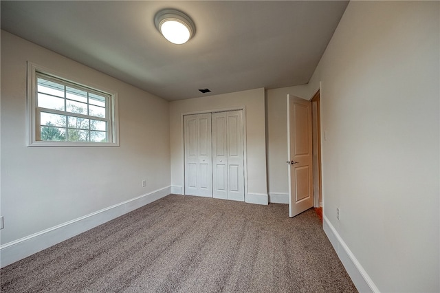 unfurnished bedroom featuring a closet and carpet flooring