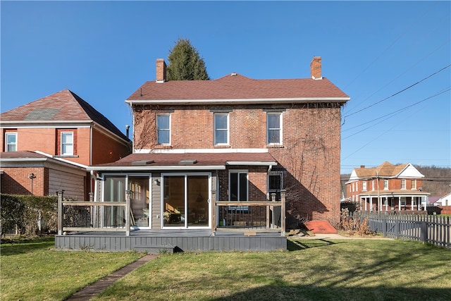 back of house featuring a lawn