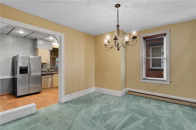 unfurnished dining area featuring baseboard heating, a chandelier, and light colored carpet