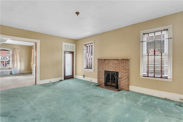 unfurnished living room featuring carpet flooring and a brick fireplace