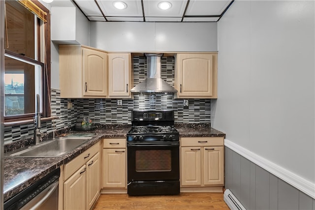 kitchen featuring wall chimney exhaust hood, black gas stove, sink, light wood-type flooring, and light brown cabinetry