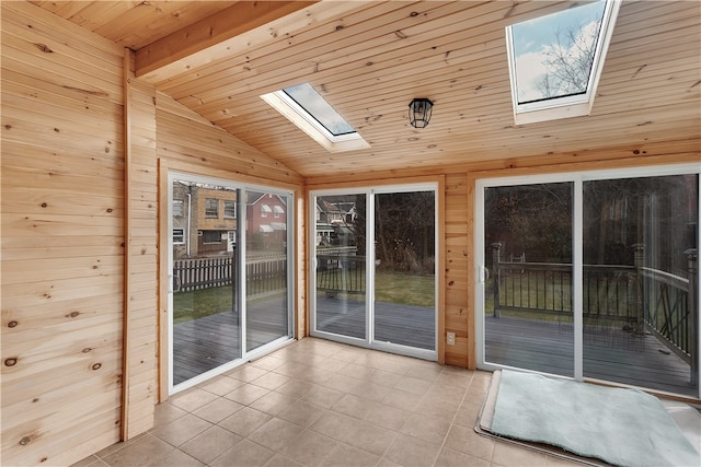 interior space featuring vaulted ceiling with skylight and wooden ceiling