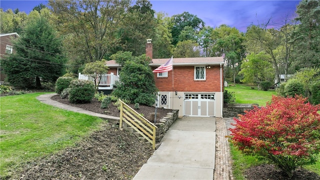 view of side of home with a yard and a garage