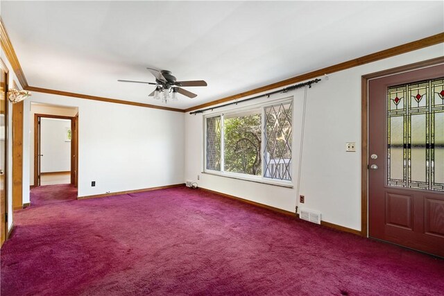 empty room with ceiling fan, ornamental molding, and carpet floors