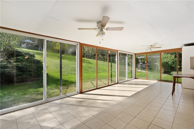 unfurnished sunroom with ceiling fan