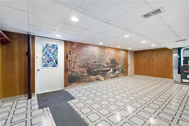 basement featuring wood walls