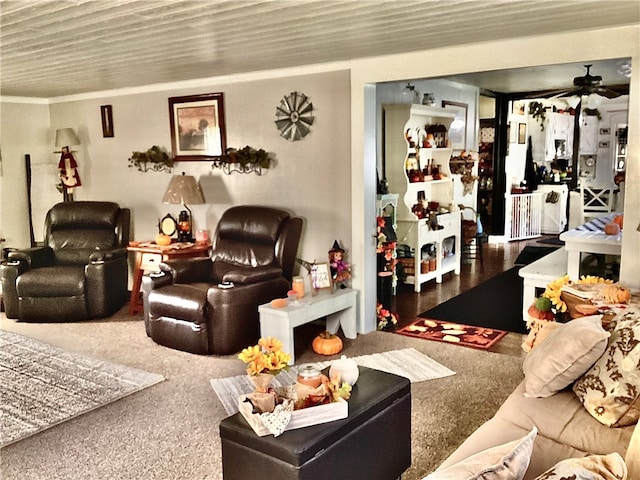 living room featuring ornamental molding, carpet flooring, and ceiling fan