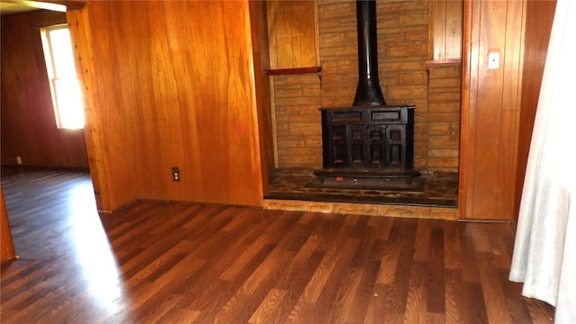 unfurnished living room with dark hardwood / wood-style floors and wood walls