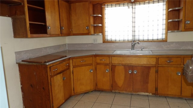 kitchen featuring light tile patterned floors, a healthy amount of sunlight, and sink